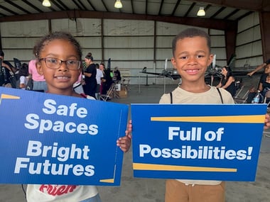 Children holding signs