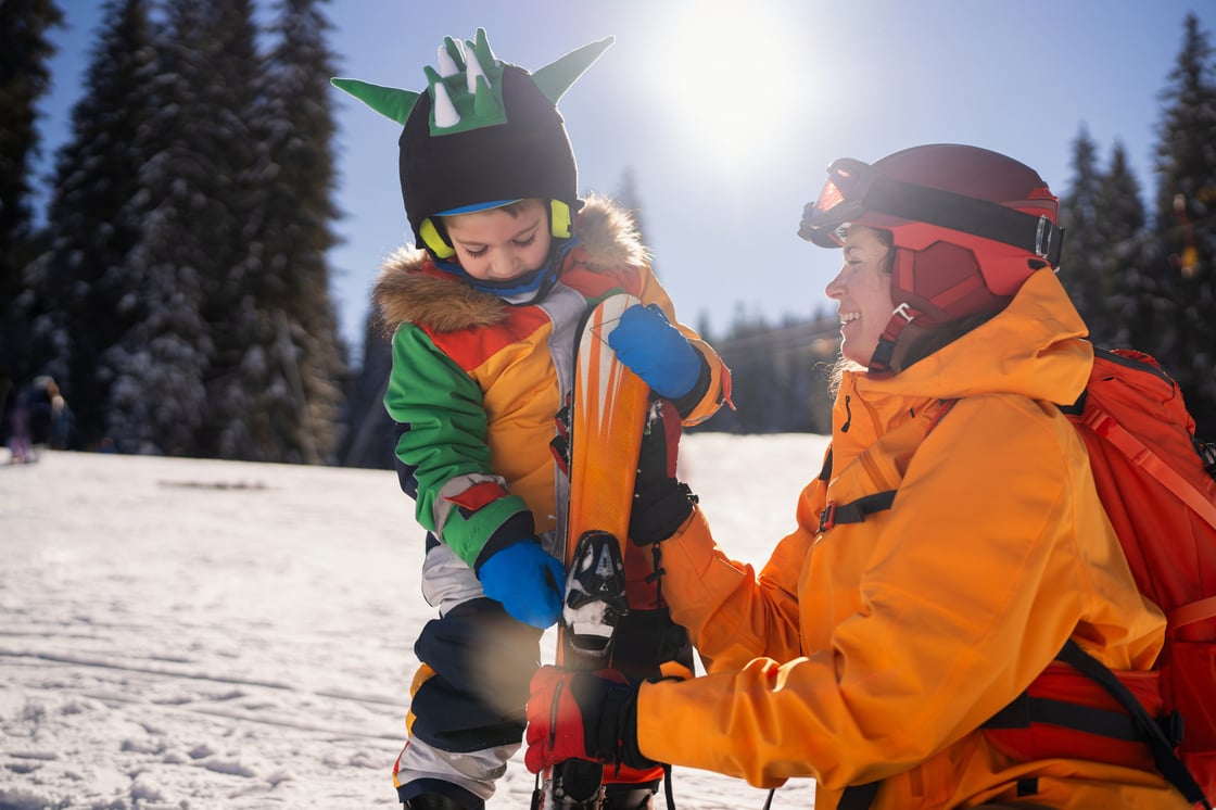 Child and parent playing in the snow